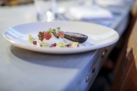 Dine at a Zinc banqueting table in a beautiful warehouse-style setting just feet away from an impressive commercial kitchen. 